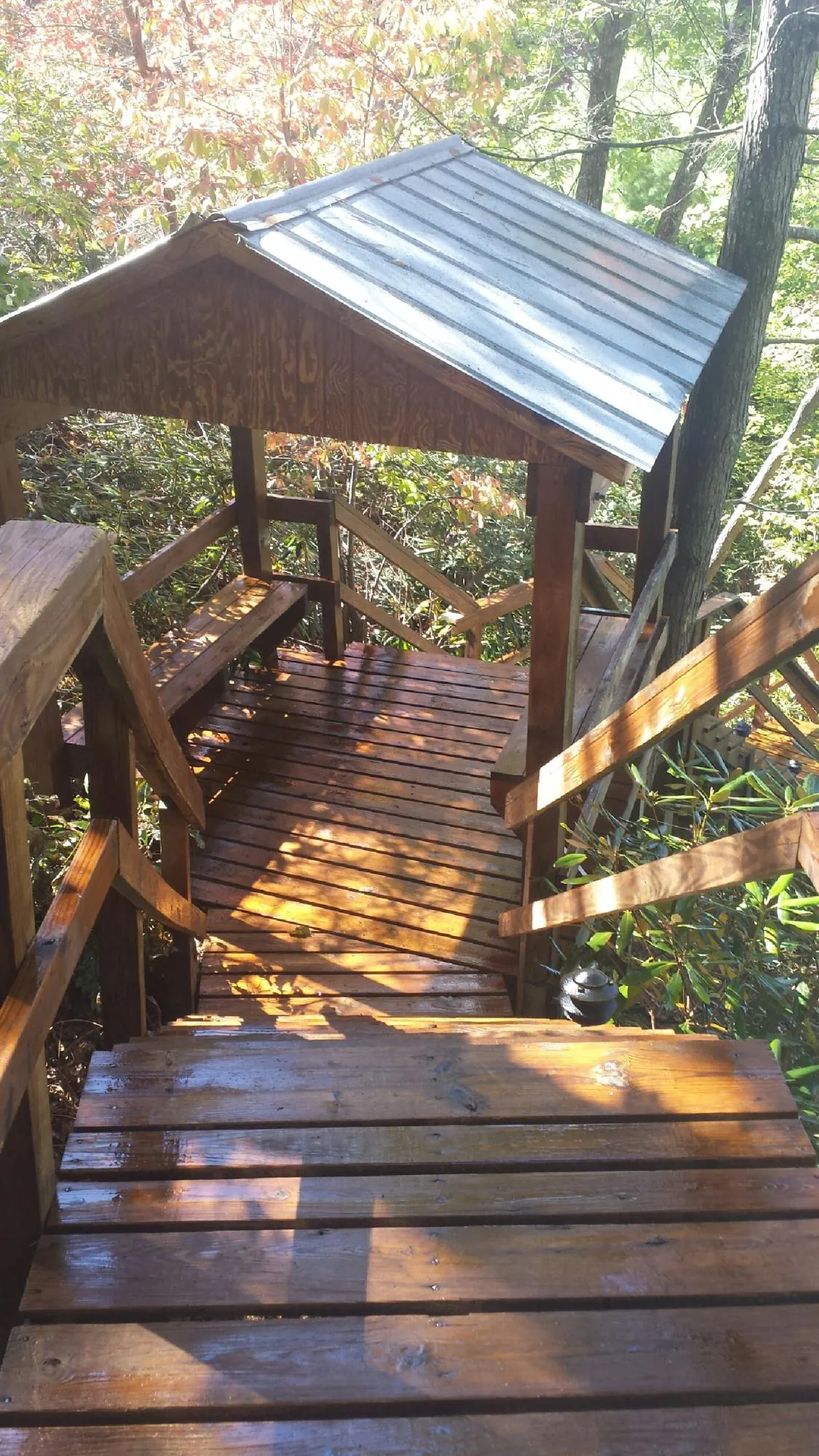 Freshly stained wood walkway and covered shelter with a metal roof in Kinderhook
